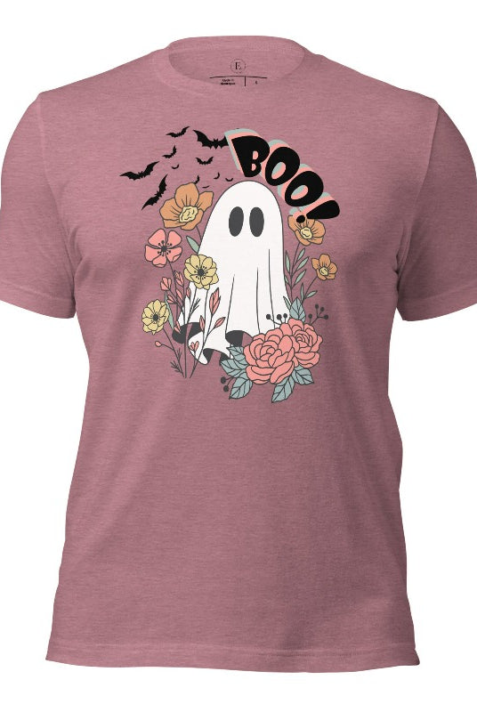 Get ready for Halloween with our cute and spooky ghost-themed shirt! Featuring a whimsical design with a cute ghost, flowers, and bats in a starry sky, it's the perfect blend of spooky and sweet on a heather orchid colored shirt. 