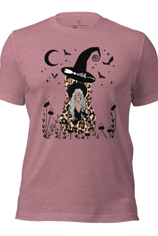 Elevate your Halloween style with our striking shirt featuring a cheetah print squash and a stylish lady donning a witch hat adorned with flowers and bats. Embrace the enchanting fusion of nature and magic on a heather orchid colored shirt. 