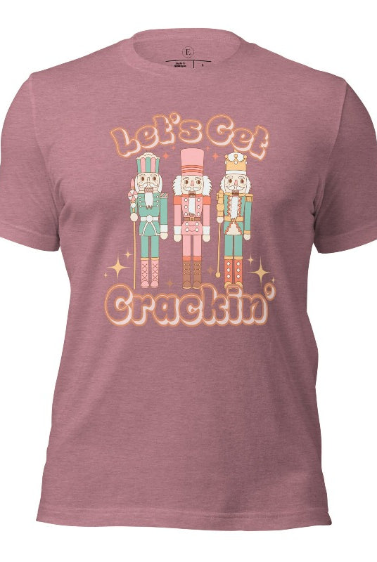 Get into the festive groove with our Christmas Nutcracker shirt that exclaims, "Let's Get Crackin'!" on a heather orchid colored shirt. 