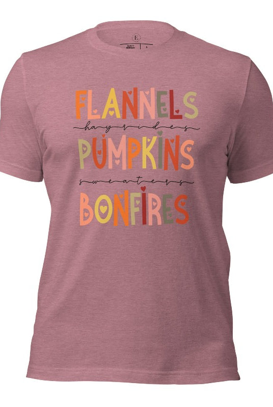 Embrace the cozy spirit of fall with our Flannel, Hayrides, Pumpkins, Sweaters, Bonfires shirt. Featuring the iconic fall elements, this shirt celebrates the season of warmth and comfort on a heather orchid colored shirt. 