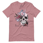 A Halloween-themed design with a skull adorned with flowers and a raven, accompanied by the text "Be Original." The shirt is soft and perfect for celebrating Halloween in style on a mauve shirt.