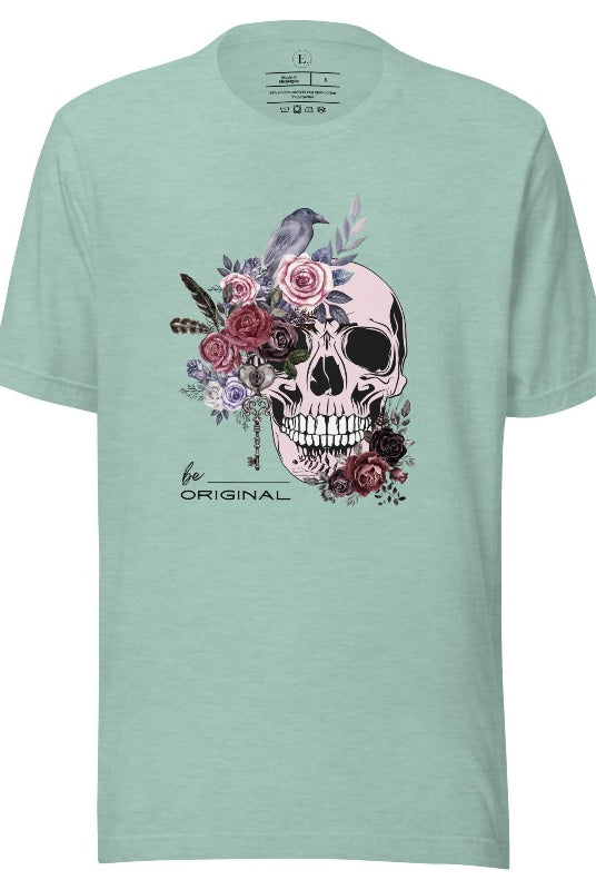 Looking for a unique Halloween shirt? Look no further! Our hauntingly beautiful shirt features a floral skull, raven, and the empowering slogan 'Be Original'. Stand out from the crowd with this unforgettable statement piece on a heather prism dusty blue shirt. 