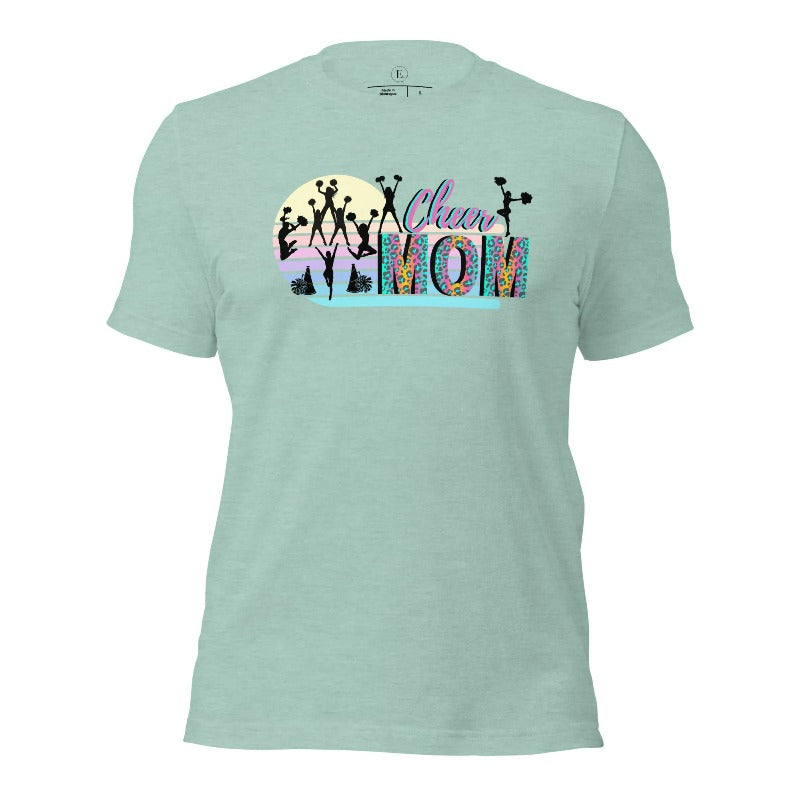 Get your cheer on with our stylish cheer mom shirt. Perfect for proud moms supporting their cheering stars. Made with love, this shirt combines comfort and fashion, letting you show off your team spirit. Join the cheer squad and cheer your heart out in style on a heather prism dusty blue shirt. 