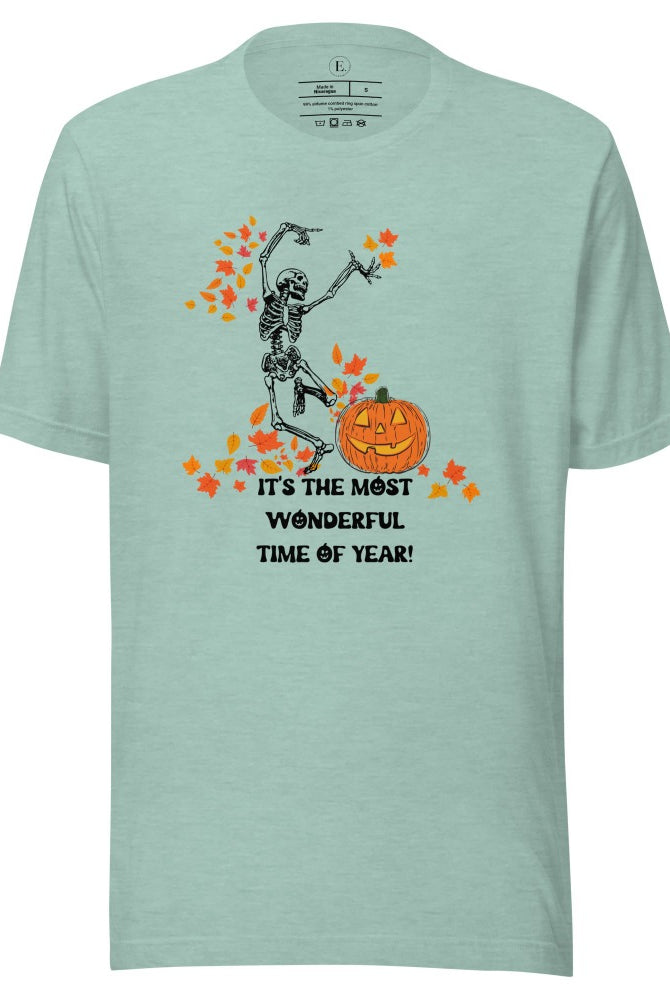 Dancing Skeleton in fall leaves with a jack-o-lantern with saying "It's the most wonderful time of year" on a heather prism dusty blue colored shirt.
