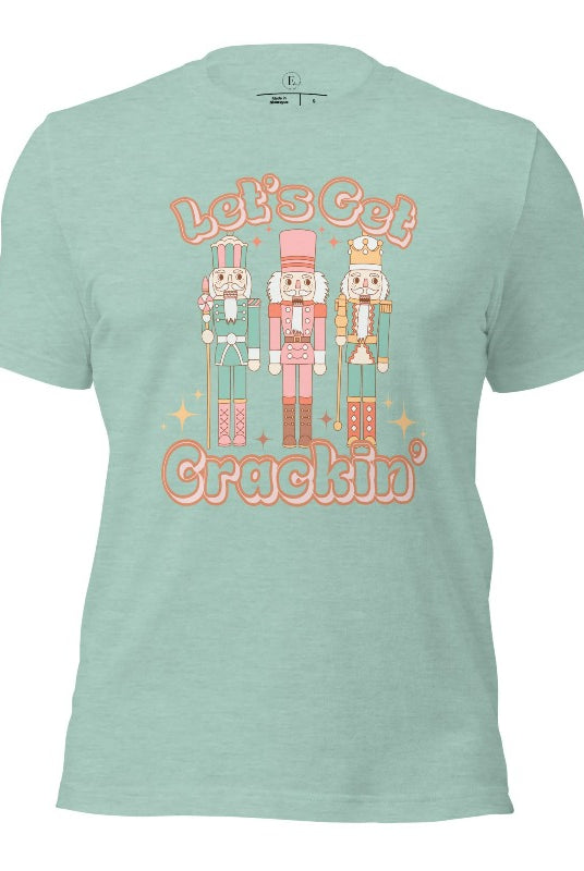 Get into the festive groove with our Christmas Nutcracker shirt that exclaims, "Let's Get Crackin'!" on a heather prism dusty blue colored shirt. 
