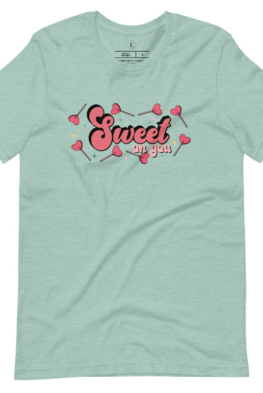 Spread the love with our charming Valentine's Day shirt featuring the endearing phrase " Sweet on You" surrounded by heart lollipops on a heather prism dusty blue shirt. 