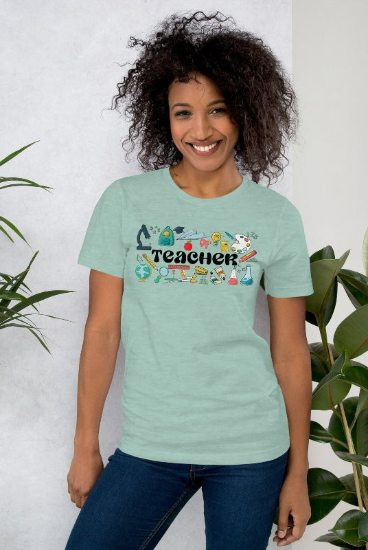 Teacher-themed graphic tee featuring the word 'Teacher' surrounded by all things related to teaching. Perfect for teacher shirts and teacher gifts. Mint blue graphic tees. 