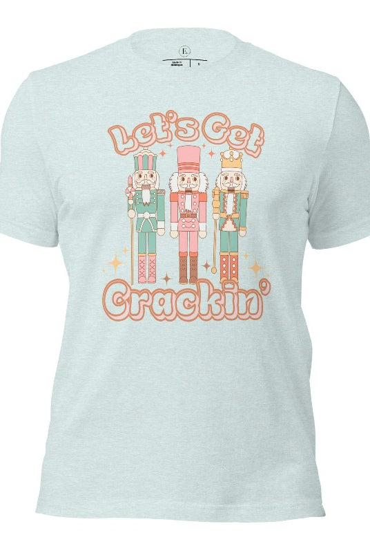 Get into the festive groove with our Christmas Nutcracker shirt that exclaims, "Let's Get Crackin'!" on a heather prism ice blue colored shirt. 