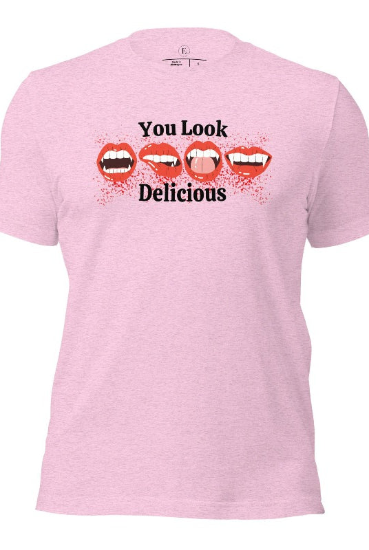 Indulge in wickedly delightful style with our vampire lips shirt. Featuring alluring lips dripping with Halloween allure, this shirt captivates with its seductive charm. The cheeky message, 'You Look Delicious,' on a heather prism lilac shirt. 