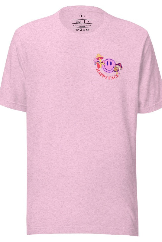 Spread positivity with our delightful t-shirt. The design features a happy face with mushrooms on the side and the words 'Happy Face' on the front pocket on a heather prism lilac colored shirt. 