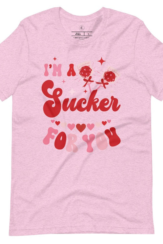 Indulge in the spirit of love with our Valentine's Day shirt! Adorned with charming Valentine lollipops and the playful saying, "I'm a sucker for you," on a heather prism lilac shirt. 