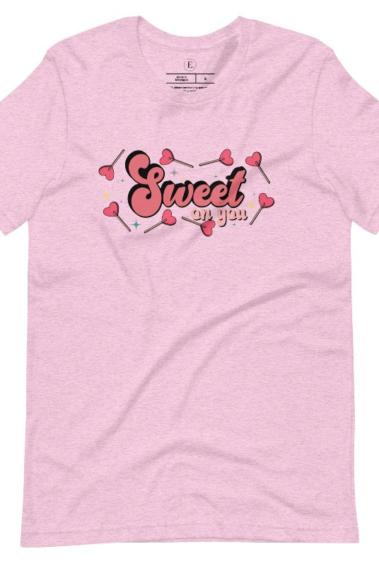 Spread the love with our charming Valentine's Day shirt featuring the endearing phrase " Sweet on You" surrounded by heart lollipops on a heather prism lilac shirt. 