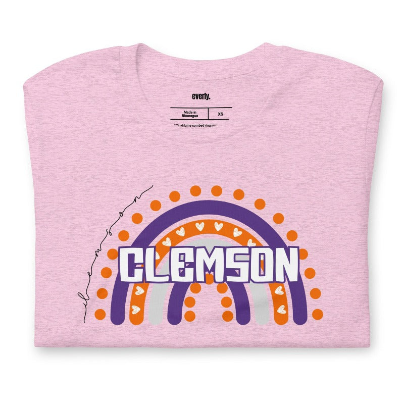 Bella + Canvas 3001 unisex shirt featuring a colorful rainbow design with the word "Clemson" in the center, representing Clemson University on a pink graphic tee.