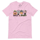 Pink t-shirt featuring a fun 'Sweet & Spooky' design with Halloween-themed ice cream cones, skulls, pumpkins, and spooky treats.