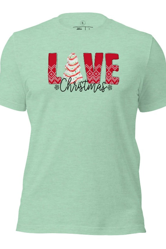Spread love and joy this holiday season with our Christmas shirt featuring the classic Christmas tree cake, which is incorporated into the word "Love" on a heather prism mint colored shirt.