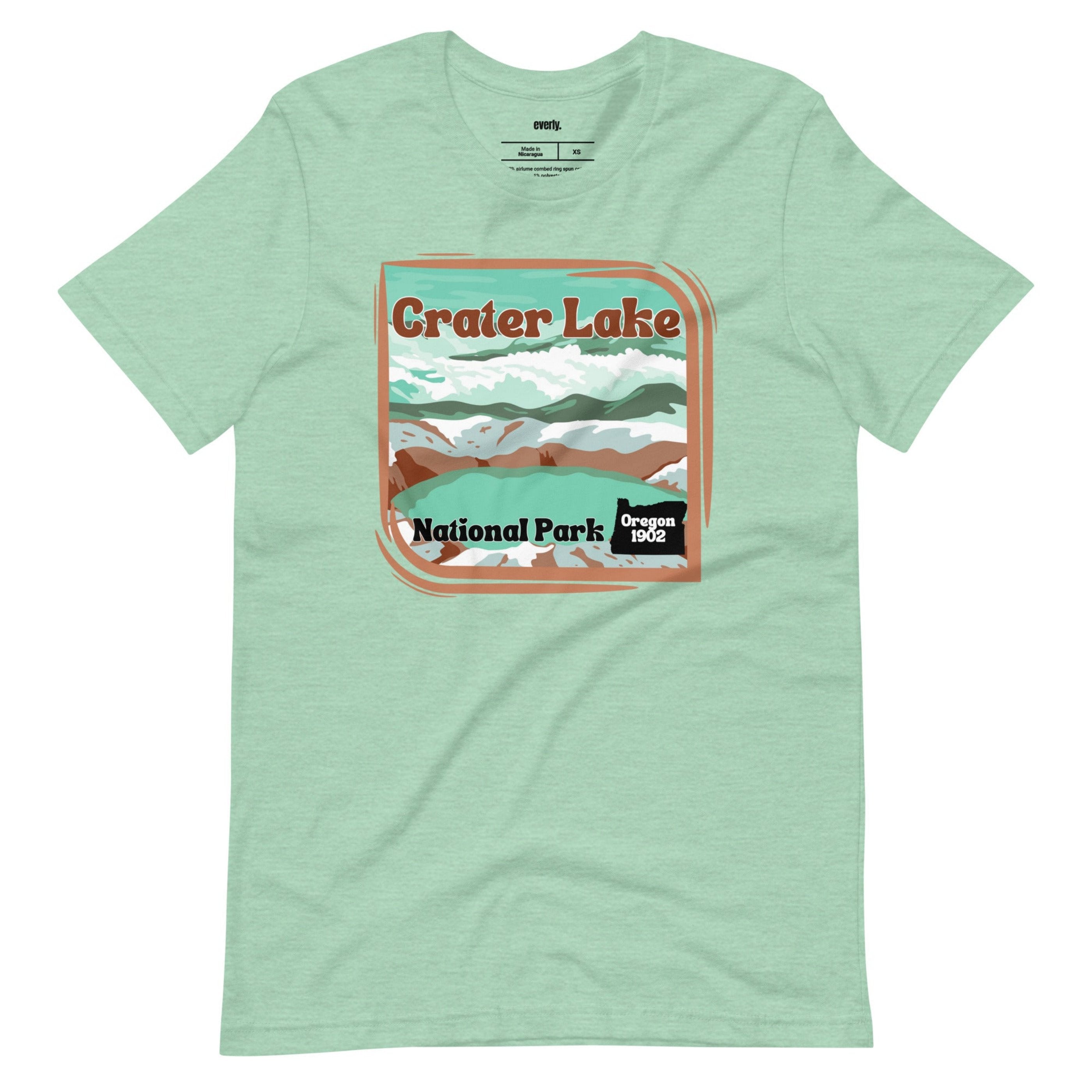 a colorful graphic of Crater Lake National Park, featuring mountains, water, and the text "Crater Lake National Park Oregon 1902 on a mint shirt. 