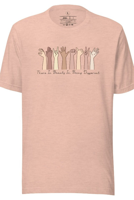 Celebrate diversity with this inspiring shirt, which features hands of different ethnicities and boldly declares "There is beauty in being different" on a heather prism peach colored shirt.