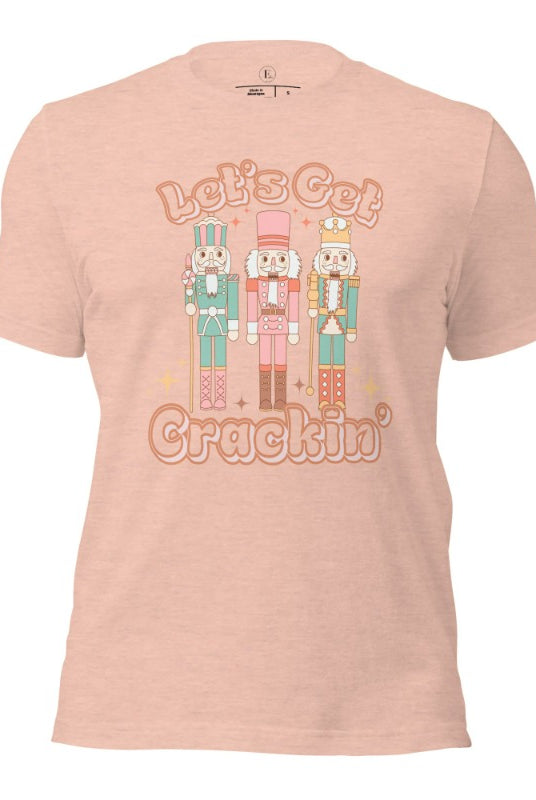 Get into the festive groove with our Christmas Nutcracker shirt that exclaims, "Let's Get Crackin'!" on a heather prism peach colored shirt. 
