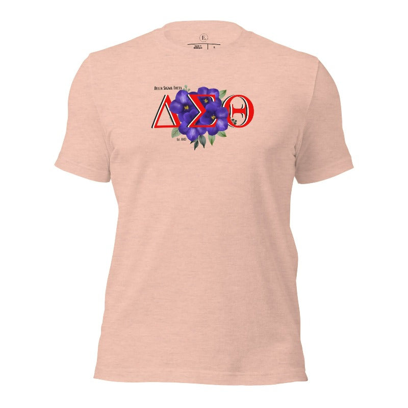 Show off your Delta Sigma Theta sisterhood with our exclusive sorority t-shirt design! The t-shirt features the sorority's letters along with the vibrant African violet, symbolizing empowerment, strength, and courage on a heather prism peach shirt. 