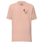 Embrace the enchanting night sky with our captivating t-shirt. Featuring a crescent moon, stars, and a spiderweb with three adorable spiders hanging down on the front pocket on a heather prism peach shirt. 
