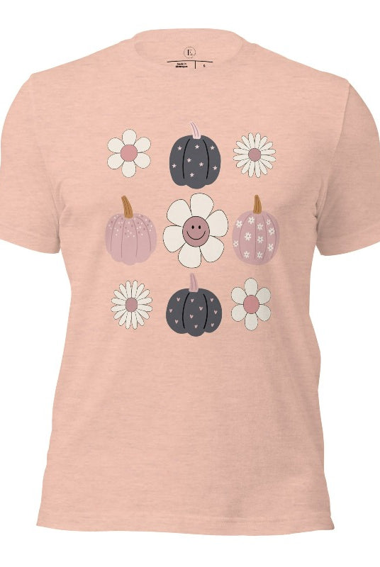 Step into retro autumn vibes with our trendy t-shirt. Featuring a delightful combination of pumpkins and retro flowers, on a heather prism peach shirt. 