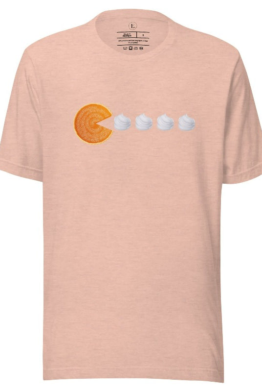 Level up your style with our playful t-shirt featuring a pumpkin pie shaped like Pac-Man devouring whipped cream swirls on a heather prism peach shirt. 