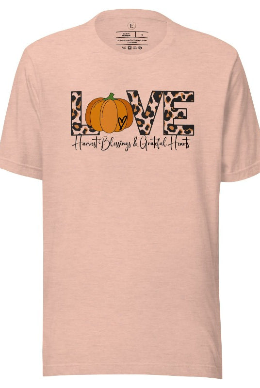 Spread love and autumn vibes with our trendy t-shirt. Featuring the word 'love' in cheetah print with a pumpkin as the 'o,' and "Harvest Blessings and Grateful Hearts' underneath on a heather prism peach shirt. 