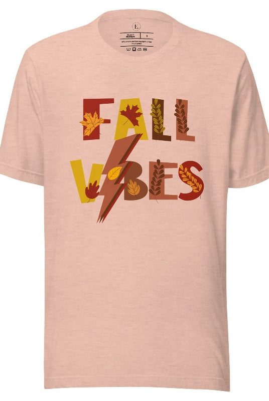 Get into the autumn spirit with our Fall Vibes shirt. Featuring the words 'Fall Vibes' with a creative twist- a lighting bolt replacing the 'I'- this shirt captures the energy of the season. Adorned with leaves, it adds a touch of nature's beauty on a heather prism peach shirt. 