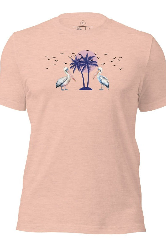 Elevate your beach style with our Beach shirt featuring two majestic pelicans facing each other. Set against a backdrop of a breathtaking sunset and a swaying palm tree on a heather prism peach shirt. 