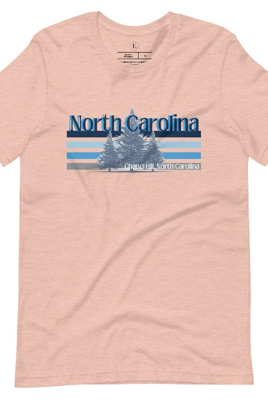 Show your school pride with this iconic North Carolina wordmark t-shirt. Made from premium materials, it features a North Carolina tree line in a the cool Carolina blue colors, representing a tradition of excellence for the nature that North Carolina offers on a heather prism peach shirt. 