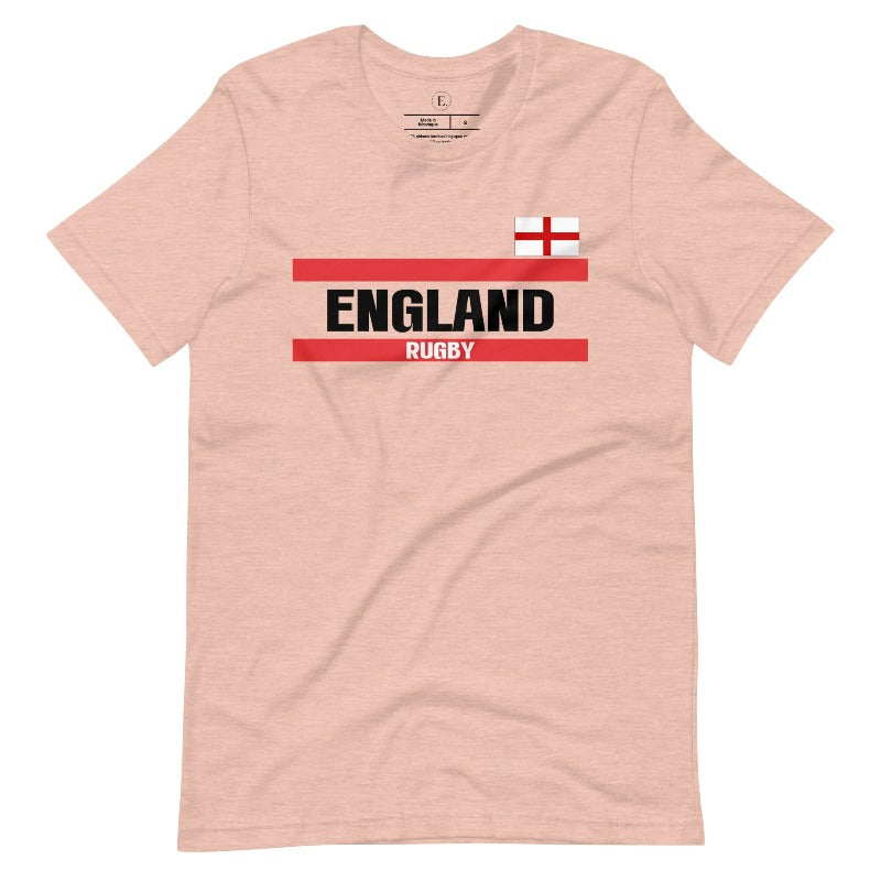 Introducing our England Rugby Graphic T-Shirt - made for rugby fans who want to show off their pride in a stylish and contemporary way! Featuring the words "England Rugby" and the iconic England flag, on a peach shirt.