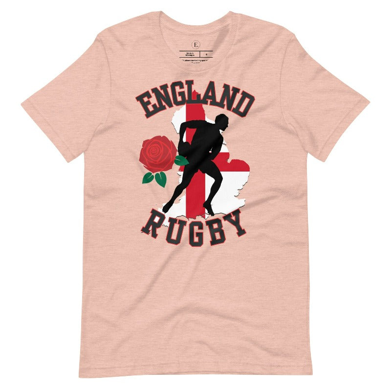 Introducing our England Rugby Graphic T-Shirt - the ultimate fusion of patriotism, rugby pride, and contemporary style! This captivating t-shirt features the words "England Rugby" and the iconic England flag artfully incorporated within the outline of the country, accompanied by a dynamic rugby player graphic on a heather prism peach shirt. 