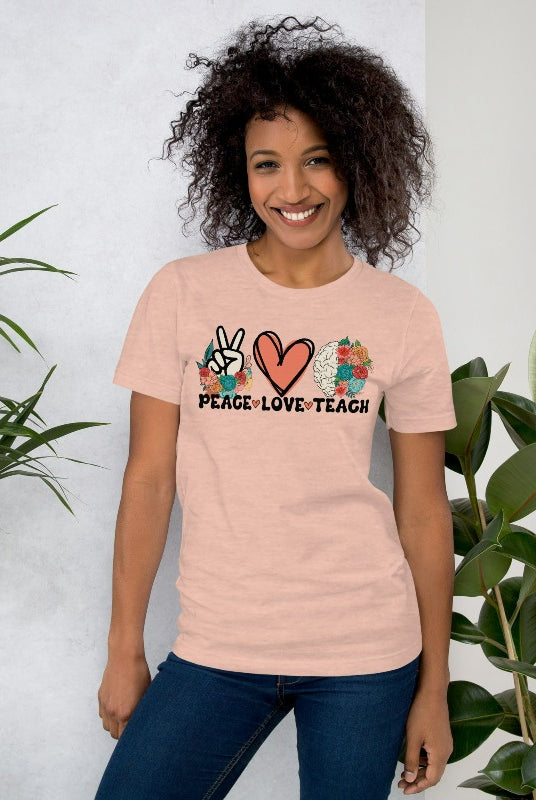 Floral design featuring the words 'peace love teach' on a teacher graphic tee - a great choice for teacher shirts and teacher gifts. Peach graphic tees. 