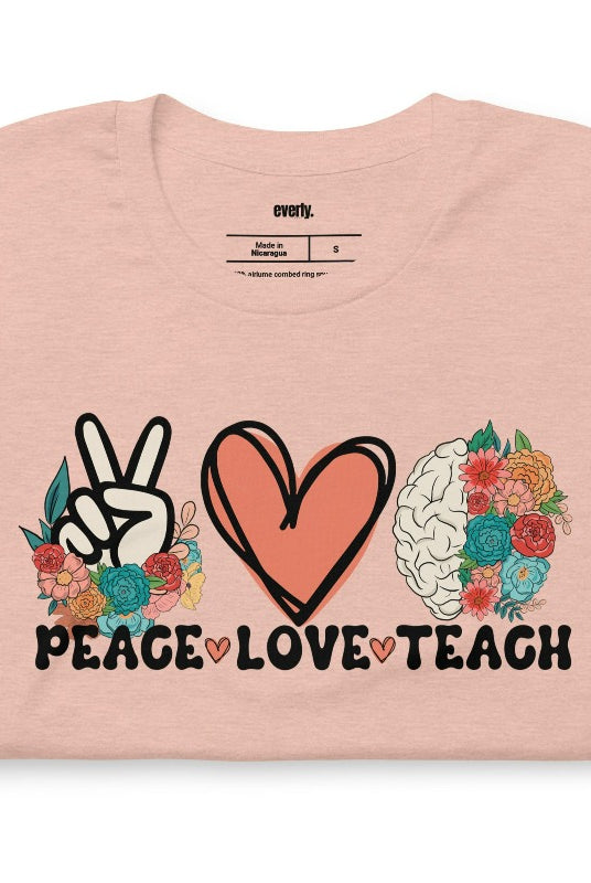 Floral design featuring the words 'peace love teach' on a teacher graphic tee - a great choice for teacher shirts and teacher gifts. Peach graphic tees. 