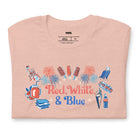 A vibrant graphic tee for the USA July 4th celebration featuring the text "Red White Blue" in bold and patriotic colors. The design is filled with various images associated with July 4th, including fireworks, American flags, stars, and stripes, evoking a sense of national pride and celebration on a peach graphic tee.