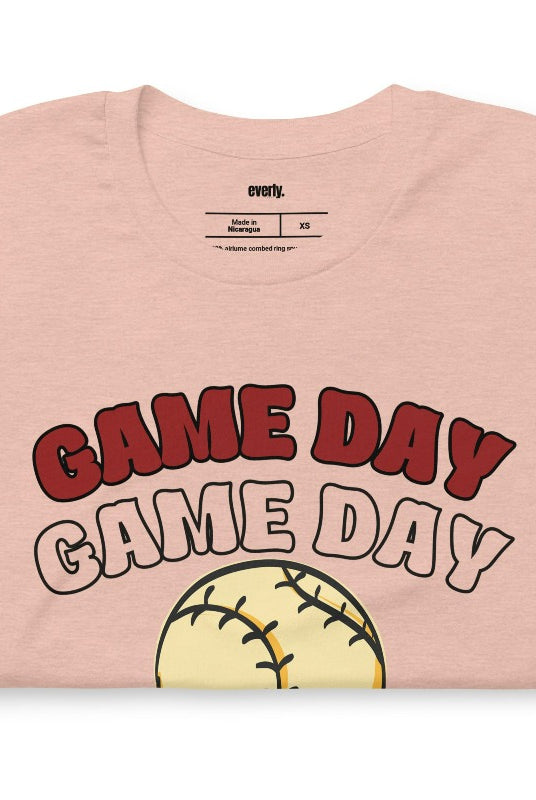 Softball game day on a heather prism peach graphic tee