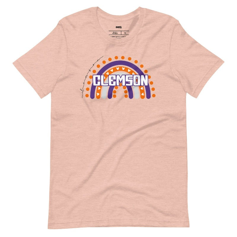 Bella + Canvas 3001 unisex shirt featuring a colorful rainbow design with the word "Clemson" in the center, representing Clemson University on a peach graphic tee.