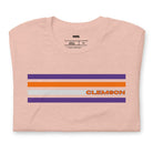 Bella + Canvas 3001 unisex T-shirt featuring a Clemson University design with purple, orange, and grey stripes and the word "Clemson" in bold orange letters on a peach shirt