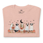 Peach t-shirt featuring a row of dogs dressed in ghost costumes with pumpkins, perfect for Halloween fun and dog lovers.