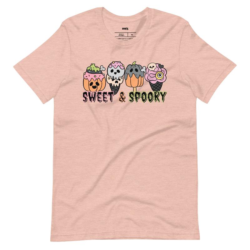 Peach t-shirt featuring a fun 'Sweet & Spooky' design with Halloween-themed ice cream cones, skulls, pumpkins, and spooky treats.