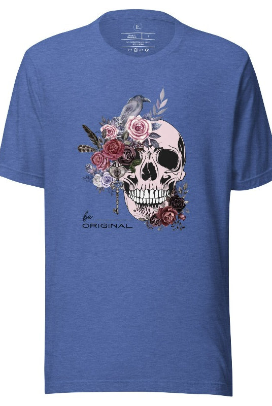 Looking for a unique Halloween shirt? Look no further! Our hauntingly beautiful shirt features a floral skull, raven, and the empowering slogan 'Be Original'. Stand out from the crowd with this unforgettable statement piece on a heather true royal blue shirt. 