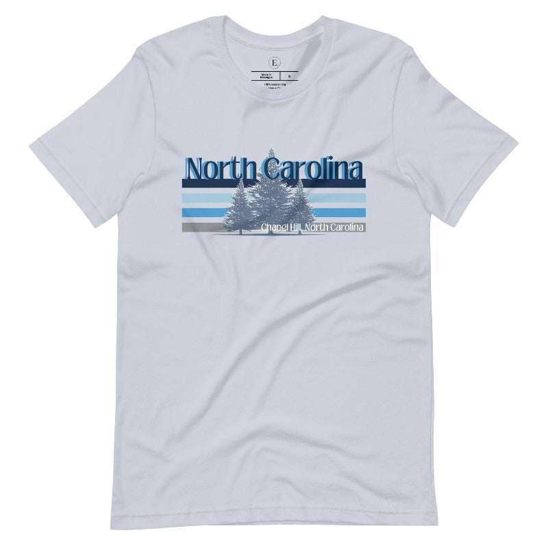 Show your school pride with this iconic North Carolina wordmark t-shirt. Made from premium materials, it features a North Carolina tree line in a the cool Carolina blue colors, representing a tradition of excellence for the nature that North Carolina offers on a light blue shirt. 