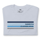 a design featuring blue stripes and "North Carolina" text on a light blue shirt.