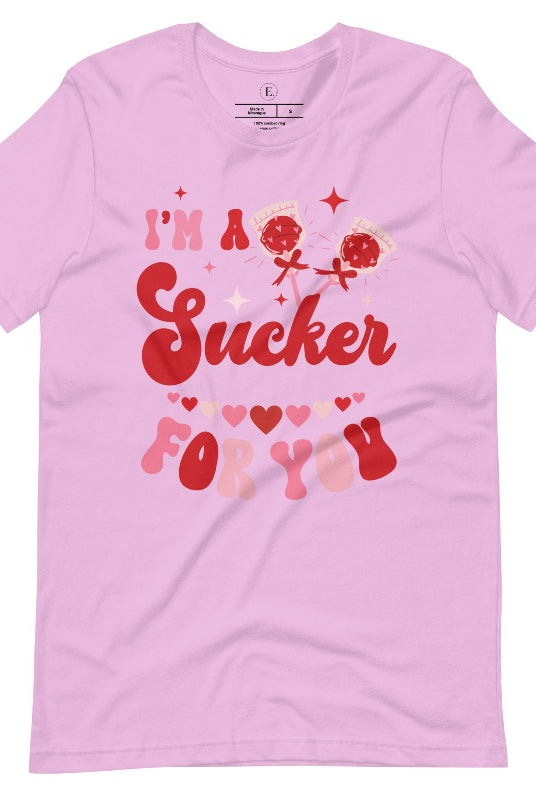 Indulge in the spirit of love with our Valentine's Day shirt! Adorned with charming Valentine lollipops and the playful saying, "I'm a sucker for you," on a lilac shirt. 