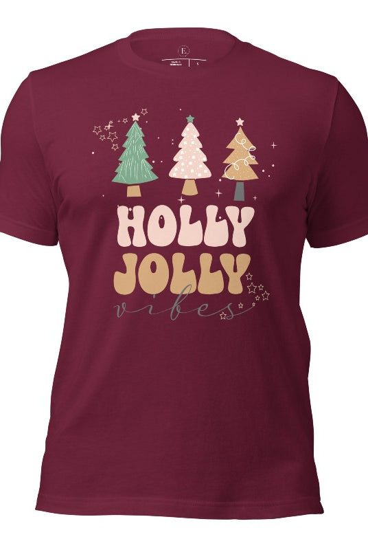 Get ready to feel the holly jolly vibes with our Christmas shirt! This festive shirt features a playful message that reads "Holly Jolly Vibes" and is adorned with cheerful Christmas trees, radiating the holiday cheer on a maroon shirt.