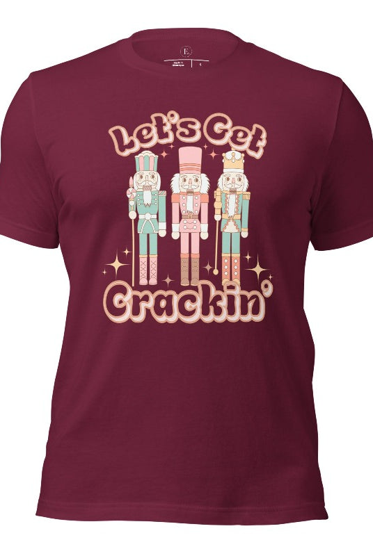 Get into the festive groove with our Christmas Nutcracker shirt that exclaims, "Let's Get Crackin'!" on a maroon colored shirt. 