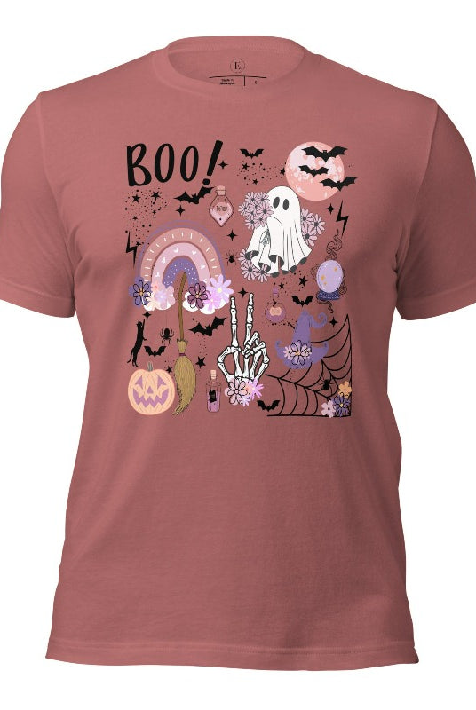 Experience the essence of Halloween with our bewitching shirt. Immerse yourself in a tapestry of Halloween symbols, from pumpkins to bats and witches, and all centered around the timeless exclamation, 'Boo!' This captivating design embodies the spirit of the season, on a mauve colored shirt. 