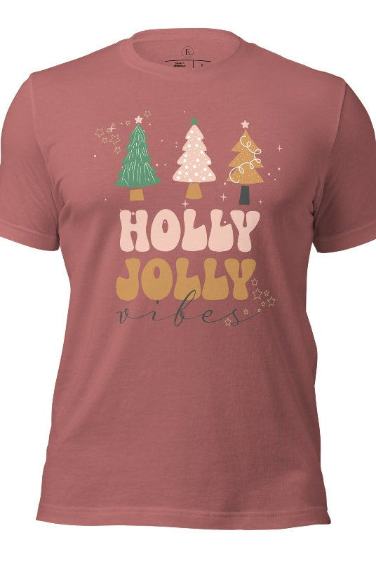 Get ready to feel the holly jolly vibes with our Christmas shirt! This festive shirt features a playful message that reads "Holly Jolly Vibes" and is adorned with cheerful Christmas trees, radiating the holiday cheer on a mauve shirt.