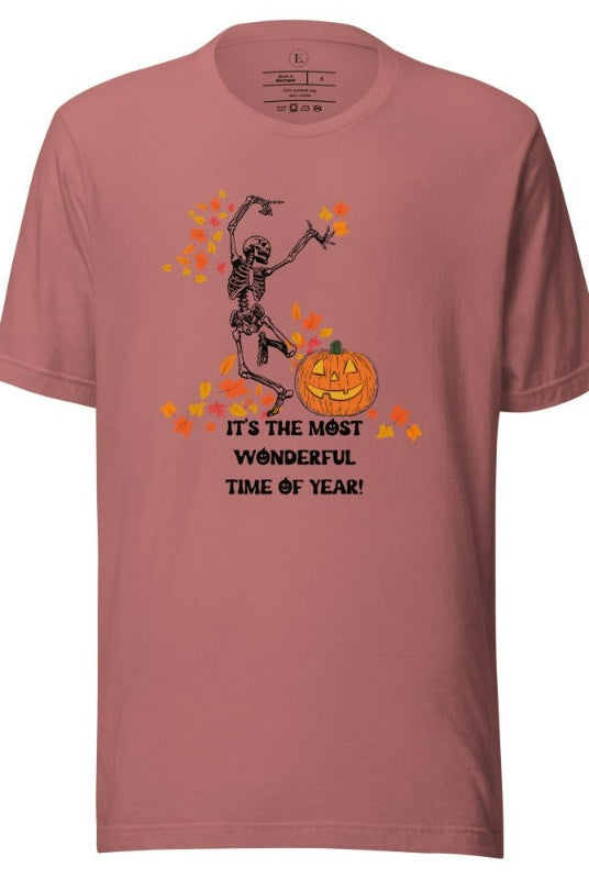 Dancing Skeleton in fall leaves with a jack-o-lantern with saying "It's the most wonderful time of year" on a mauve colored shirt.