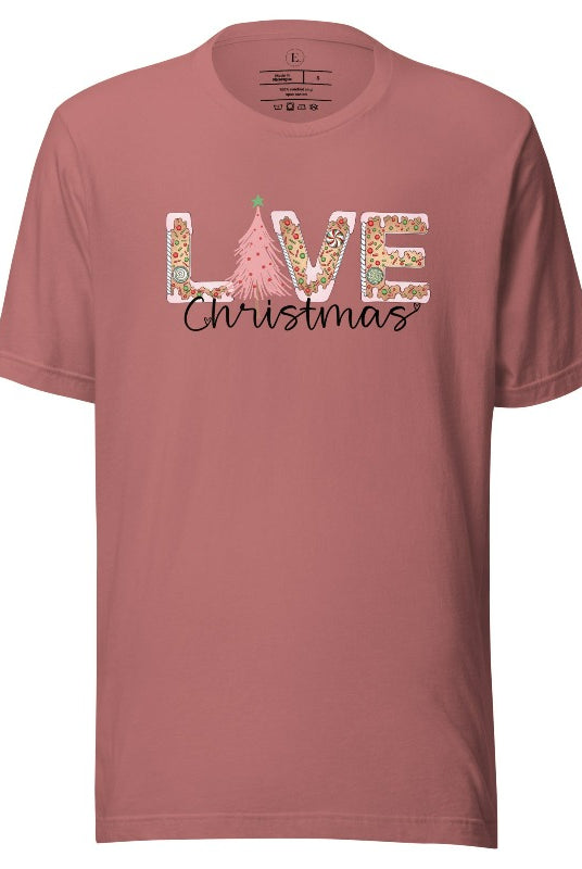 Get ready to celebrate the holiday season in style with our Christmas shirt featuring cute gingerbread cookies arranged to spell out the word "Love" on a mauve colored shirt.